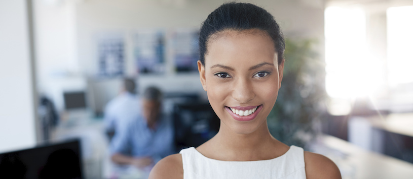 Woman smiling in an office setting.