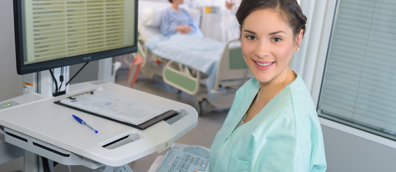 A woman working on a computer in a medical field.