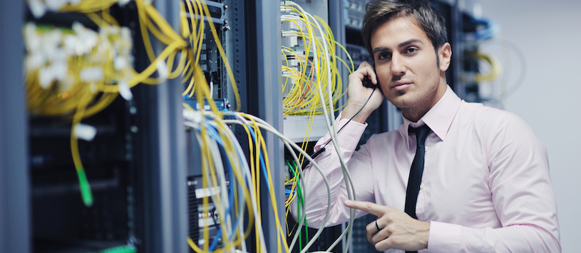 A Technician working on computer wiring.