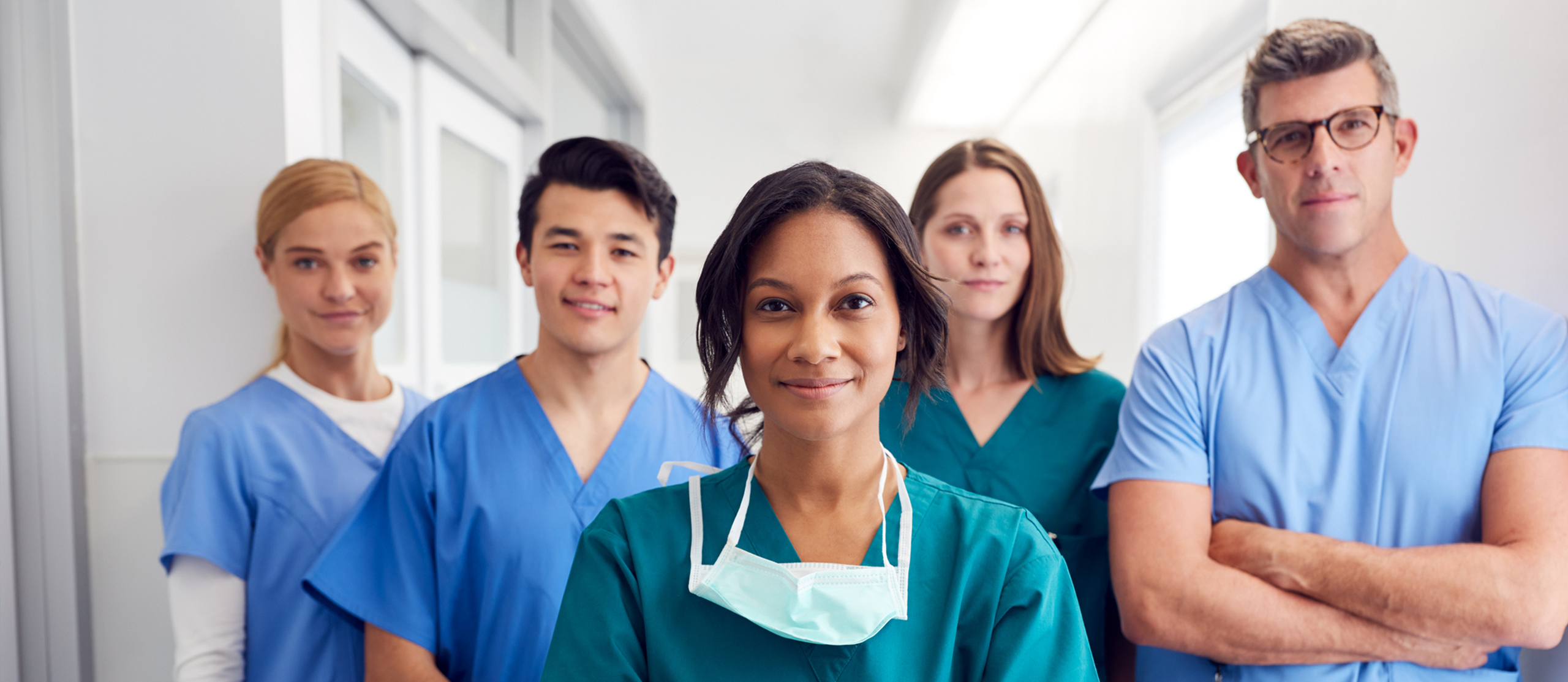 Healthcare professionals standing together in a medical setting.